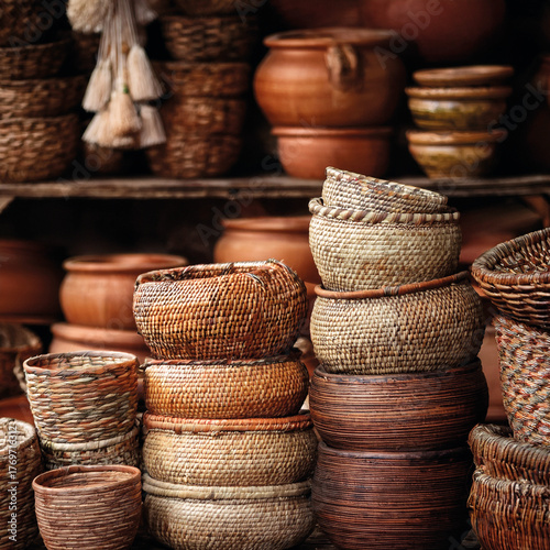 Stack of handwoven wicker baskets in earth tones, in an Indian market