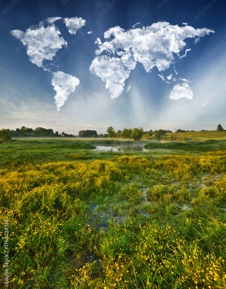 Fototapeta premium World Map Clouds Over Morning Meadow