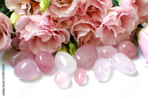 Rose quartz crystals and pink eustoma flowers. Minerals for women. Genuine semi-precious stones. Healing crystals.