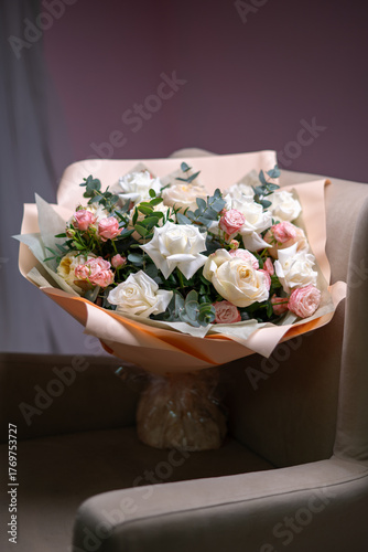 Spring bouquet of mixed flowers on vintage gray wall background behind