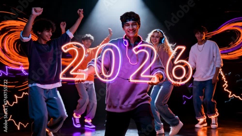 Five adults dance on stage with neon 
