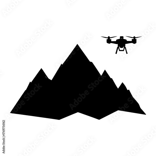 Drone flying over jagged mountain peaks silhouette