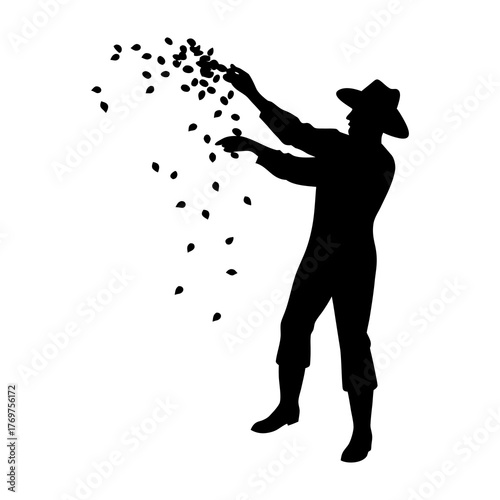 Silhouette of a farmer sowing seeds by hand