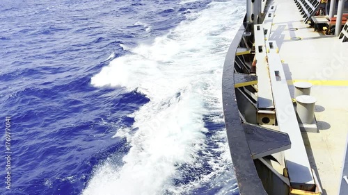 Cargo ship sailing in ocean with strong wind and waves crashing against hull — dynamic maritime scene showing the power of the sea and the resilience of ocean-going vessels in fresh wind conditions 5