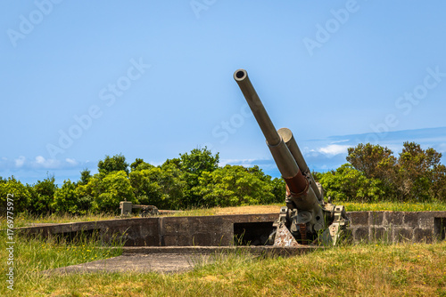 A vintage British 9.4 cm fixed anti-aircraft gun from 1940, located in a coastal fort on Terceira Island, Azores, Portugal. This preserved World War II artillery piece was part of the island’s militar