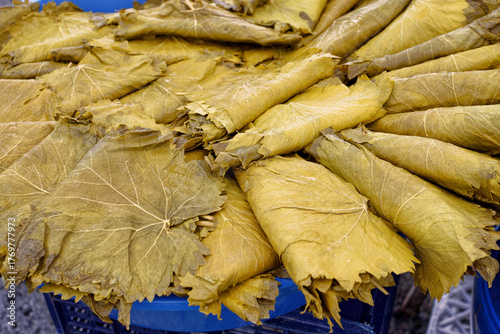 Brined grape leaves prepared for stuffed dishes in the market.