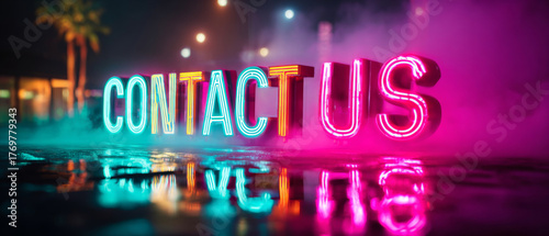 Bright neon lights spell out Contact Us on a dark, reflective surface with colorful city lights in the background