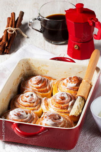 Cinnabons, cinnamon rolls topped with a cream of cream, cheese and sugar.
