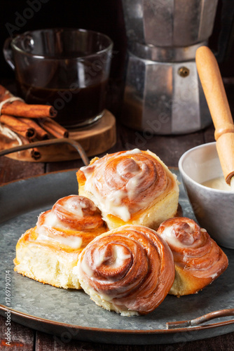 Cinnabons, cinnamon rolls topped with a cream of cream, cheese and sugar.