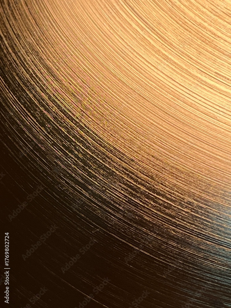Obraz premium Curved line pattern on a golden colored surface with light and shadow, abstract artistic background