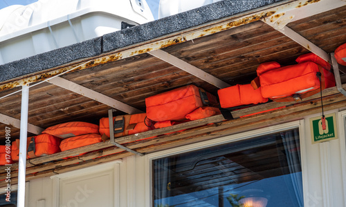 Closeup view of bright orange lifejackets.
