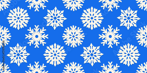 Seamless pattern with white paper cut out snowflakes on a blue background. Winter and Christmas inspired design perfect for holiday wrapping, seasonal backgrounds, festive crafts, or greeting cards.