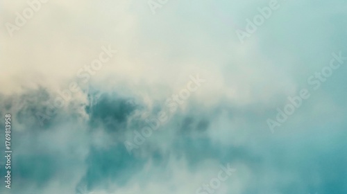 Soft, diffused image of clouds in varying shades of teal and cream