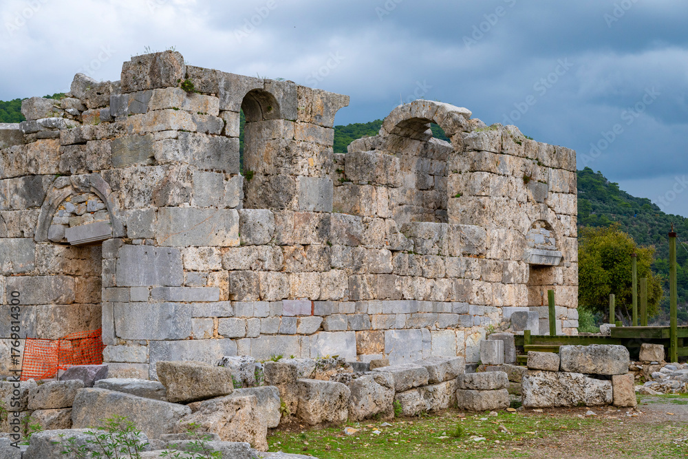 Naklejka premium Kaunos (Carian: Kbid Lycian: Xbide Ancient Greek: Καῦνος; Latin: Caunus) ancient city was a city of ancient Caria and in Anatolia, a few kilometres west of the modern town of Dalyan. Amphitheatre area