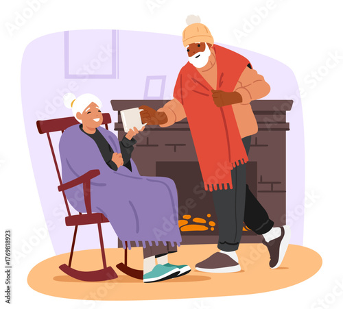 Senior loving couple warming nearby home fireplace in living room while feeling frozen at home