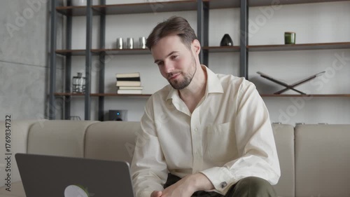 Confident Man Having Video Call On Laptop From Modern Home Interior