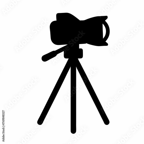 Silhouette of a camera with a lens mounted on a tripod stand