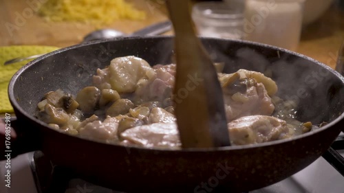 Delicious combination of chicken, mushrooms, and onions cooked in pan on stove in kitchen. Perfect for family dinners or quick, flavorful lunches