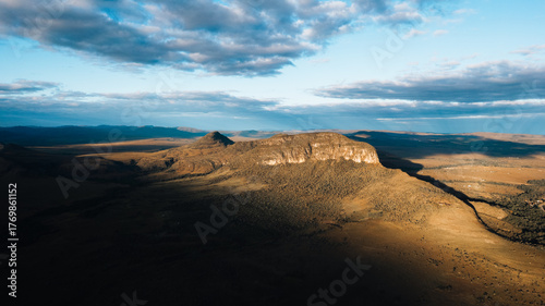 Morro da Baleia aerial view, Chapada dos Veadeiros, mountains, green fields with buritis, Jardim de Maytrea, Alto Paraiso de Goias at golden hour sunset