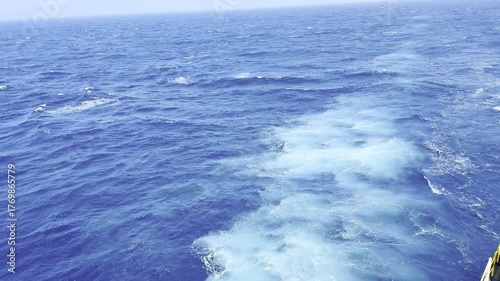 Cargo ship sailing in ocean with strong wind and waves crashing against hull — dynamic maritime scene showing the power of the sea and the resilience of ocean-going vessels 4