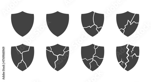 Set of eight cracked shield symbols in various stages of damage, from intact to heavily fractured, presented in a dark gray monochrome palette on a black background, ideal for graphic design, web