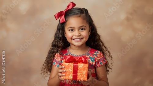 A smiling young girl with curly hair holds a wrapped gift against a warm background. Concept of childhood joy, gift-giving, and celebration is beautifully portrayed.