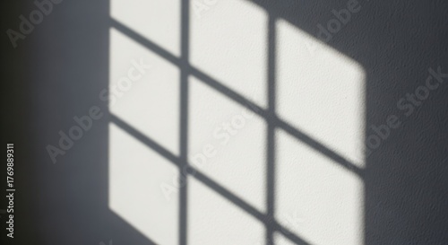 Geometric shadow pattern cast by a window pane on a plain surface isolated on white background