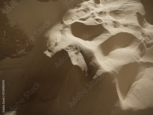 Fototapeta Naklejka Na Ścianę i Meble -  Aerial view of sand dunes with soft shadows and natural abstract patterns formed by wind

