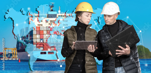 Two engineers in helmets wi...