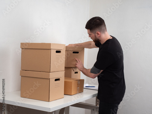 Man organizes cardboard sto...