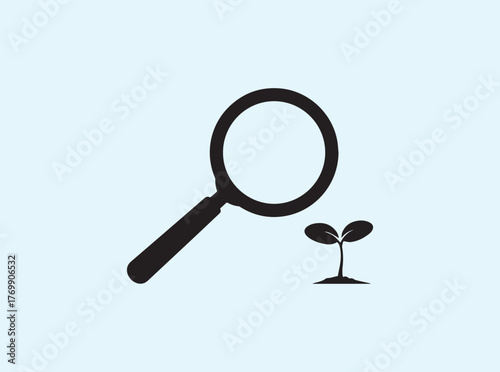 Silhouette of magnifying glass over seedling isolated on white background symbolizing scientific discovery and nature study
