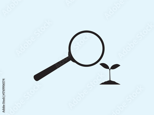 Black silhouette magnifying glass viewing sprout isolated on white background representing environmental observation
