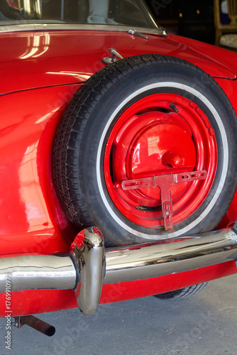 Tableau sur toile Rear-mounted spare tire, red steel wheel and whitewall