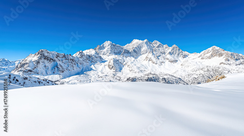 Snowy peaks under clear blue sky create serene high altitude landscape