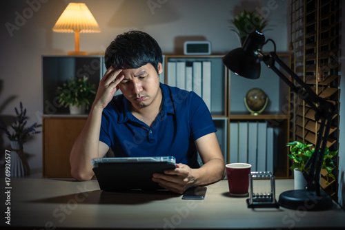 Quadro su tela stressed man using tablet at night