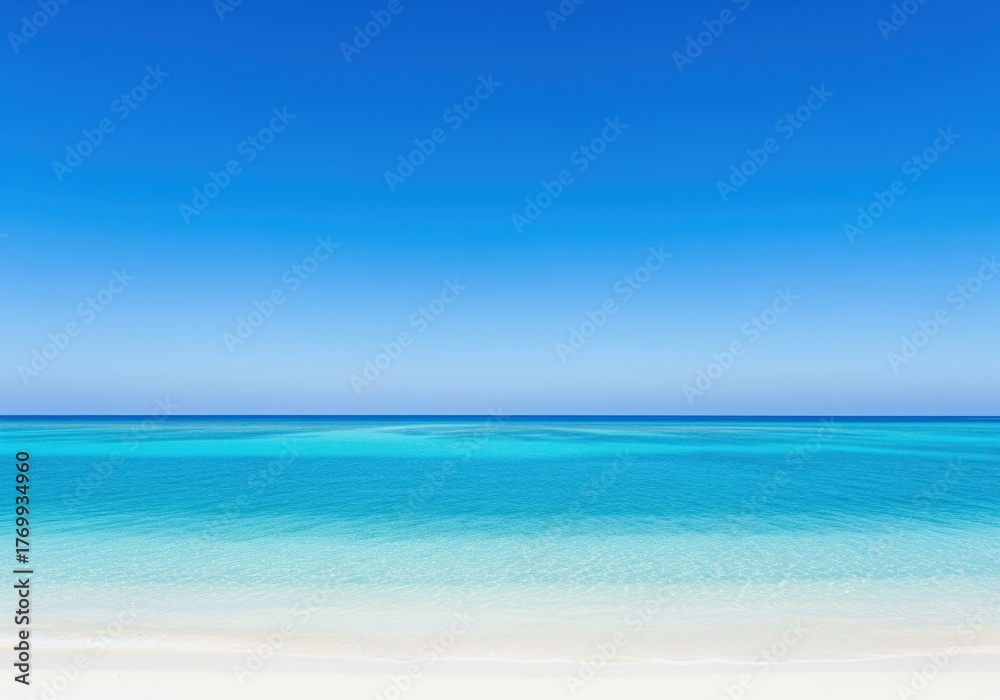Obraz premium Idyllic tropical seascape featuring clear turquoise ocean water and pristine white sand beach