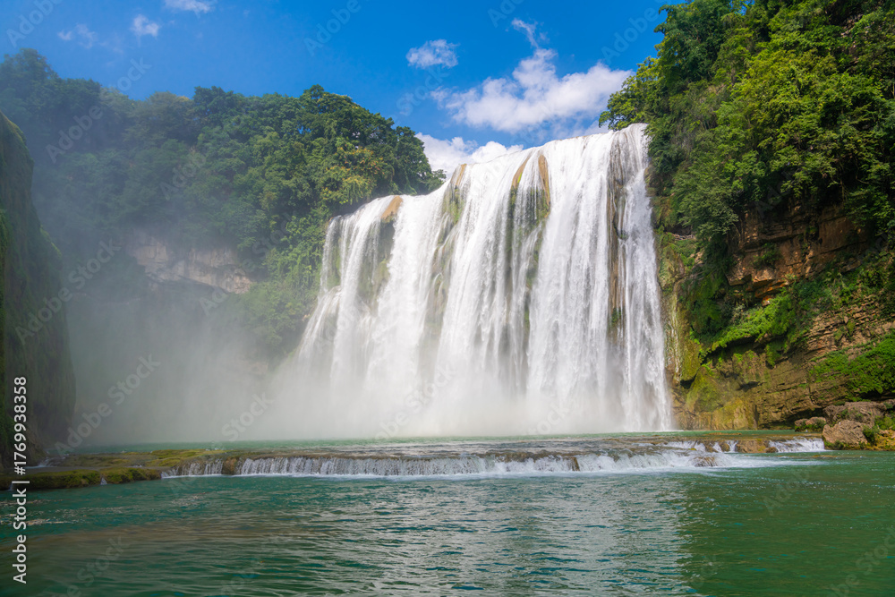 Fototapeta premium Close up on Huangguoshu Waterfall is a famous tourist attraction in Guizhou, China, summer picture, the waterfall is full of water