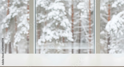 White table top with blurred winter forest view through window background