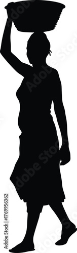 Fotografie Silhouette of Woman Carrying Basket on Head While Walking Barefoot Isolated on W