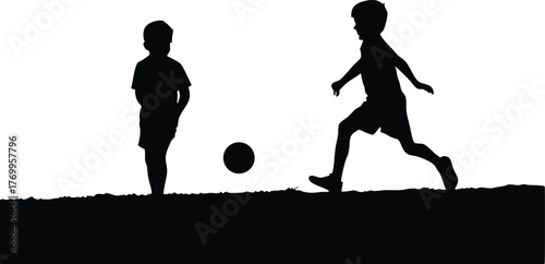 Silhouette of Two Boys Playing Soccer Together