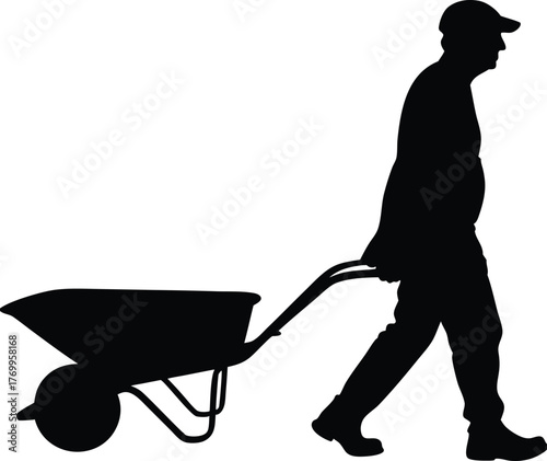 Silhouette of Man Walking Forward Pushing a Wheelbarrow with Cap Side View
