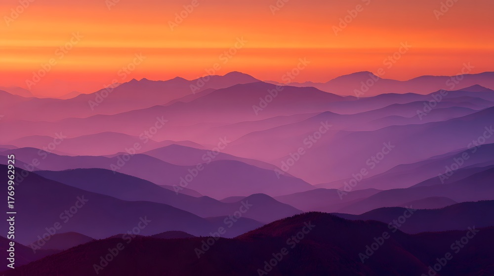 Fototapeta premium Layered mountain ridges display vibrant purple and orange hues during twilight illumination