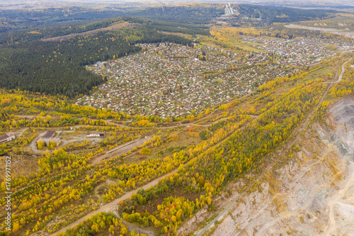 Autumn view from above of village on edge of a stone quarry
