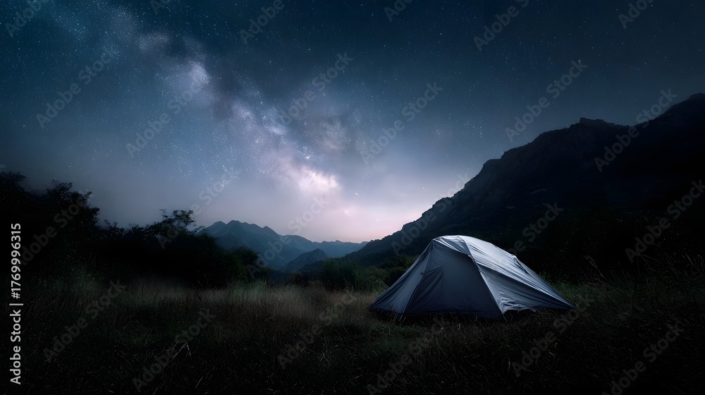 Obraz premium A tent is pitched in a mountain meadow under the vast starry Milky Way at night