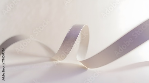 drape. A white ribbon curving downward against a minimalist gray background. wellbeing guides, coaching materials, designed for mental health education and mindfulness programs, clarifies learning.