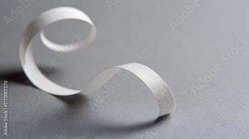 drape. A white ribbon curving downward against a minimalist gray background. wellbeing guides, coaching materials, designed for mental health education and mindfulness programs, clarifies learning.