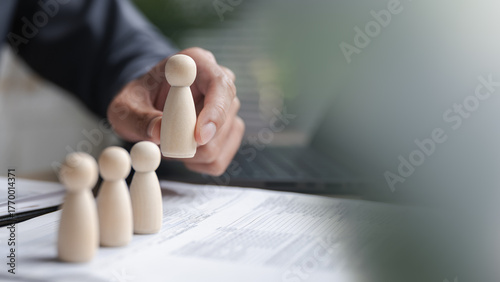 Fotografie hiring, recruitment, hr, employee, selection, Business person selecting wooden human figures, representing hiring process, employee recruitment, and talent management in human resource development