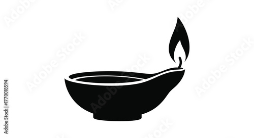 A simple black silhouette of a traditional oil lamp with a bright flame burning representing light and tradition silhouette