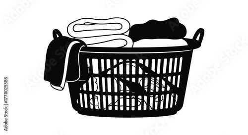 Black and white illustration of a laundry basket filled with folded clothes and a towel hanging over the side silhouette