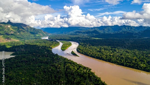 Breathtaking aerial view of Amazon River winding through lush rainforest and majestic mountains beneath dramatic cloudy skies, capturing the beauty and scale of nature's untouched paradise